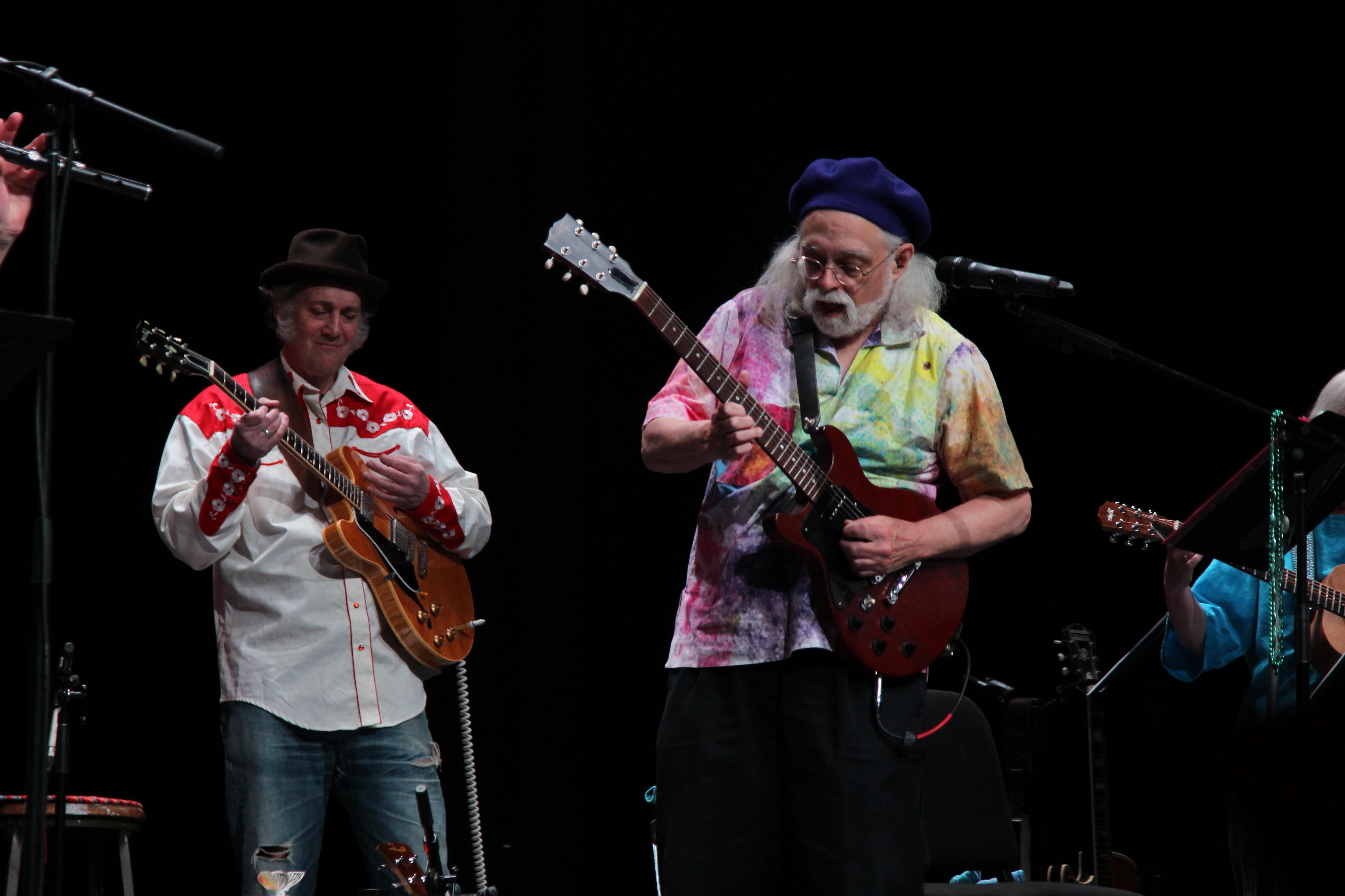 2 professors from MU play guitar on stage